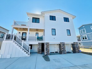 A two-story house with a front porch, a staircase, and a garage. - RENOVATED HOME ON THE OCEAN BLOCK! (Bethany Beach)