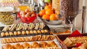 A buffet with various food items including fruits, pastries, and cereals. - CORFU GOLD LUXURY SUITES (Corfu)