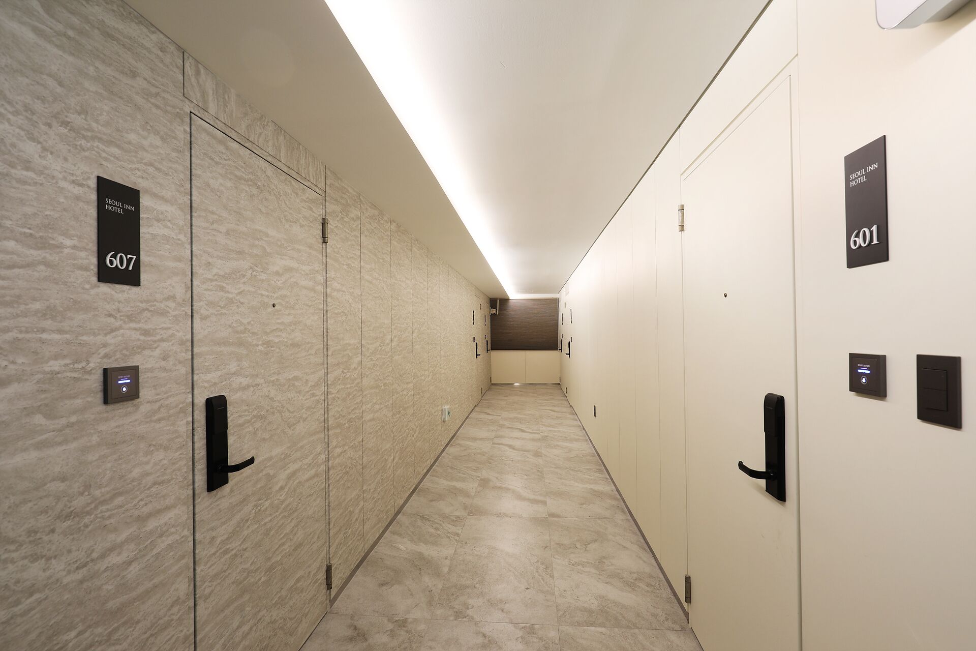 A hotel hallway with lockers numbered 607 and 601, equipped with digital keypads.