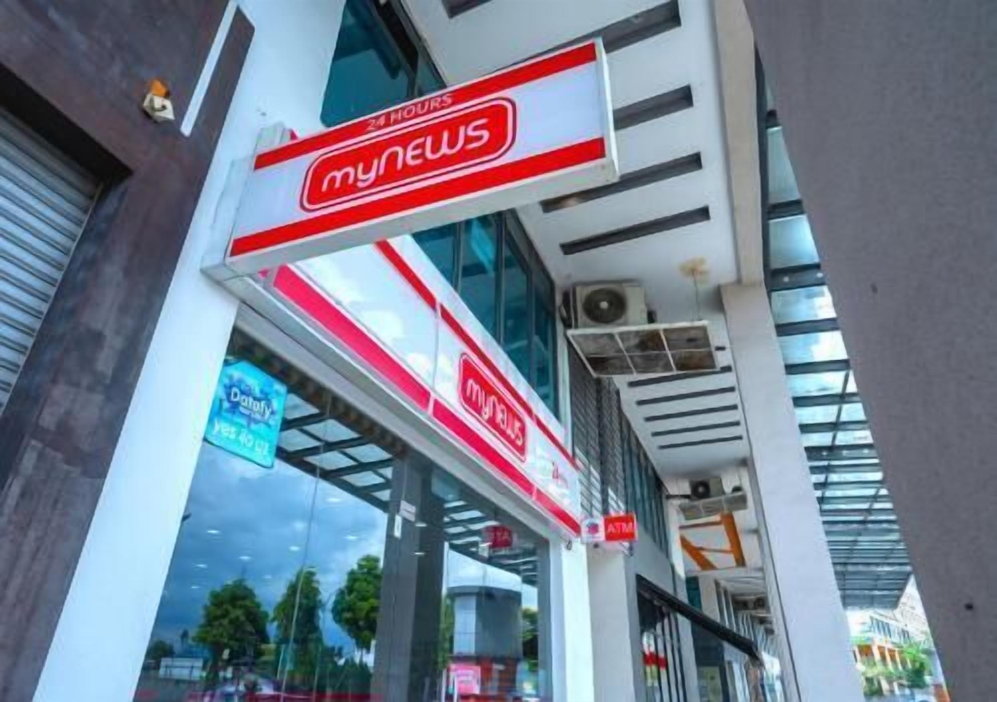 A modern building with a prominent 'mynews' sign, large windows, and a glass facade.