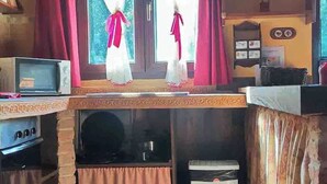 A compact kitchen with a microwave, stove, and sink. - THE OLD WOMAN'S HOUSE (Carancos)