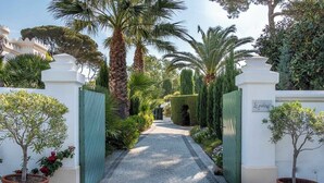 A pathway leading to a gated area with a sign reading "Le palais".