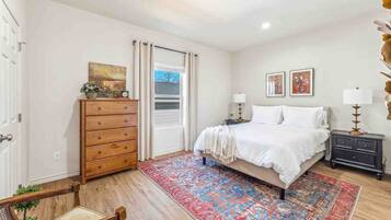 2 habitaciones, escritorio y tabla de planchar con plancha