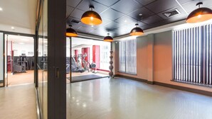 A gym with exercise equipment, large windows with blinds, and pendant lighting. - For Students Only Canvas The Heights in Birmingham (Birmingham)