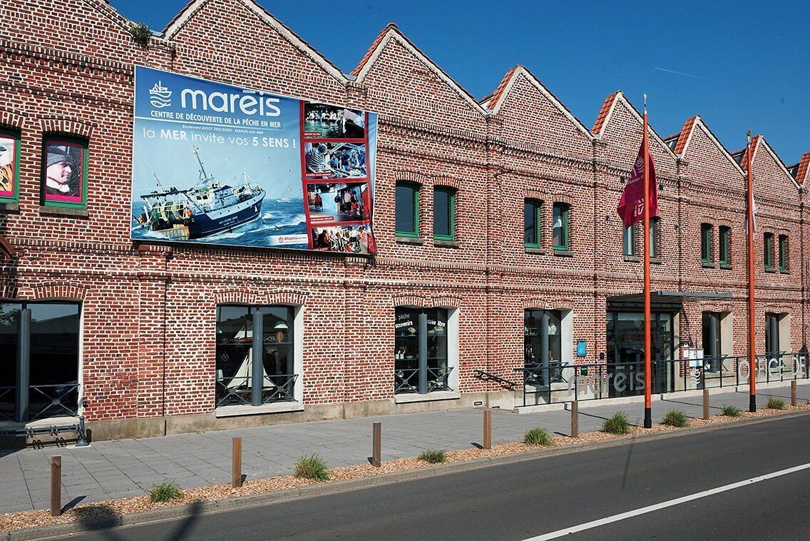 A brick building with a large poster advertising a maritime museum.