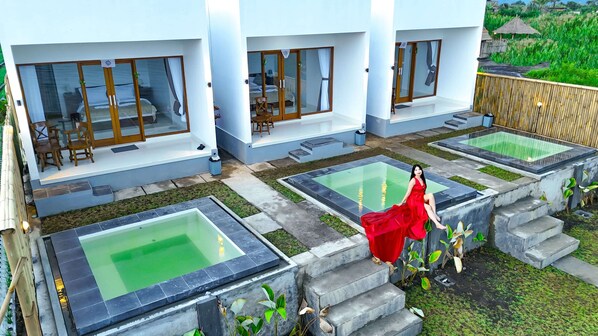 Relax in a serene outdoor setting with multiple pools and seating areas.