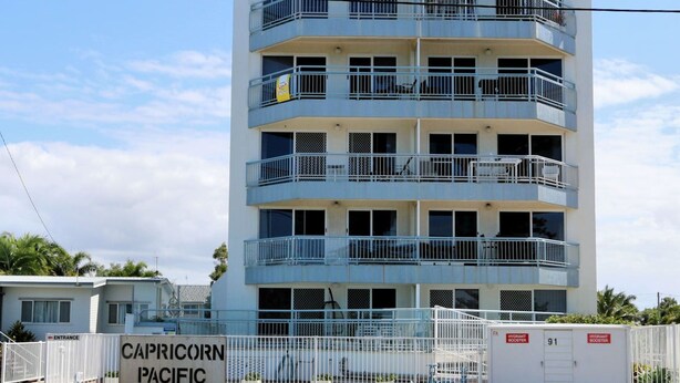 A multi-story building with balconies, a gated entrance, and a sign indicating 'CAPRICORN PACIFIC'. - Capricorn Pacific - 2 Bedroom, 2 bathroom apartment with Ocean views (Bargara)