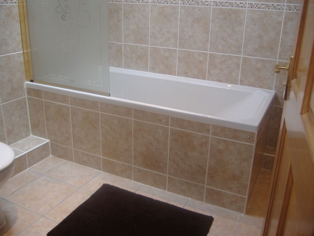 Un baño con bañera, inodoro y zona de ducha.
