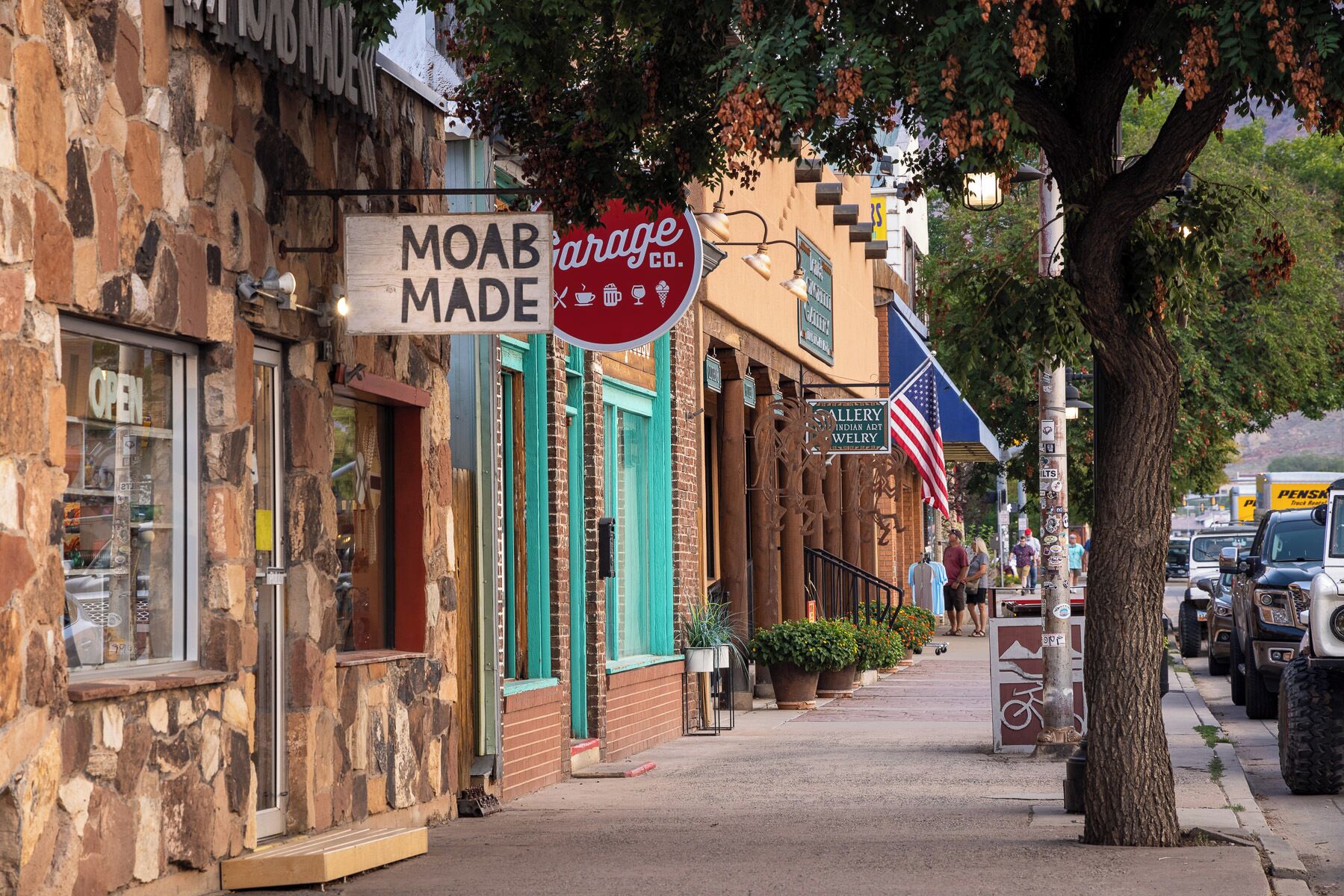 A street with various storefronts, including a coffee shop and an art gallery.