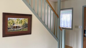 A staircase with wooden handrails and a bench at the bottom. - Charming farmhouse in Historic Spring City with AC, WiFi, and full kitchen. (Spring City)