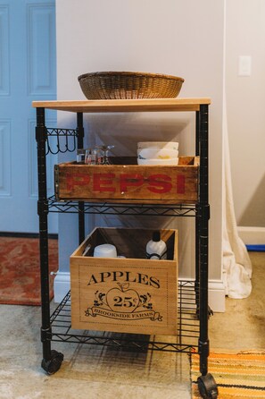 A vintage cart with a woven basket and wooden crates, perfect for storing essentials.