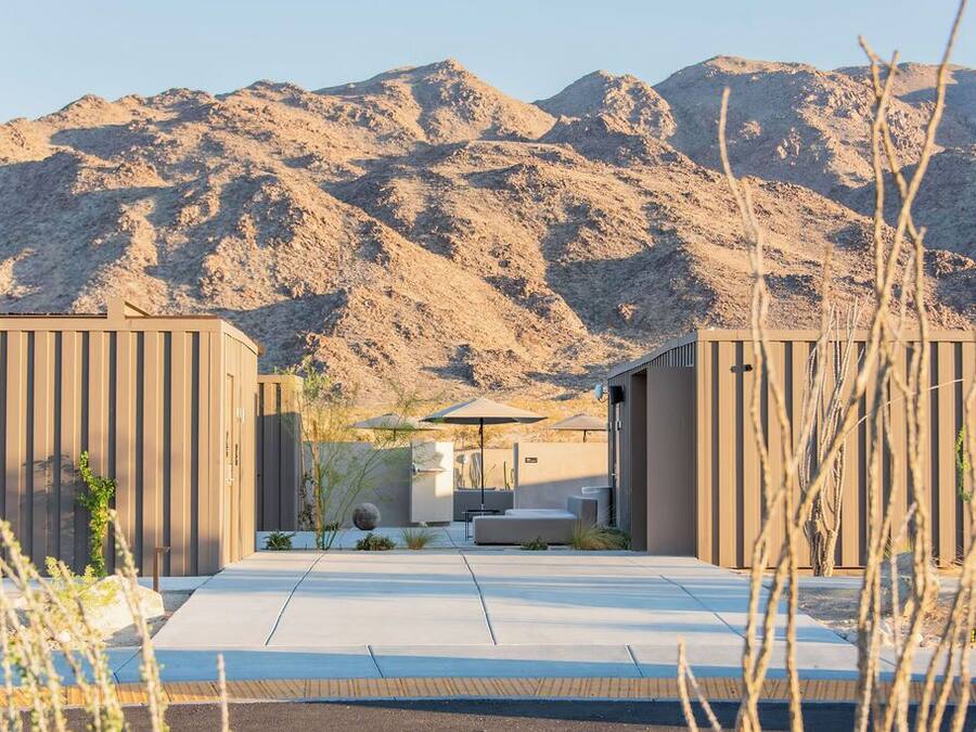 A modern building with a flat roof and a large entrance.