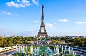 The Eiffel Tower with a fountain in the foreground.