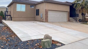 A residential house with a garage, a stone accent wall, and a driveway with a stone edge. - Pleasant Stay Place - New Build/Zion/Sand Hollow (Hurricane)