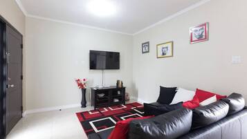 Deluxe Apartment | Living area | Flat-screen TV