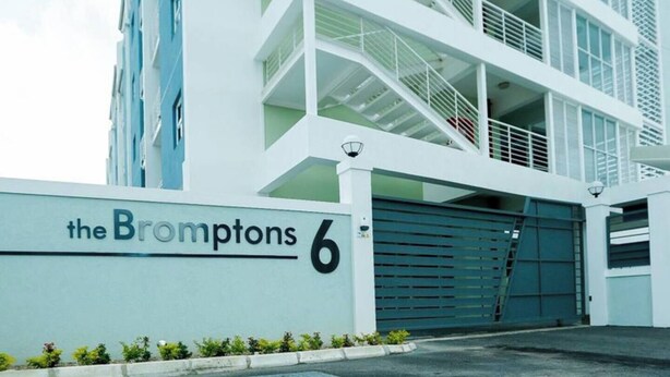 A modern building with a sign reading "the Bromptons 6". - The Brompton's Luxury Apt (Kingston)