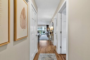 Enter a serene space with a hallway leading to a room featuring a balcony view.