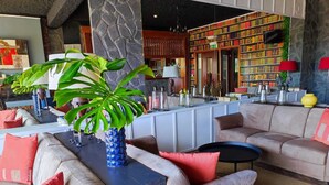 Ein stilvoller Lounge-Bereich mit Sofas, einem Couchtisch und einer großen Topfpflanze.