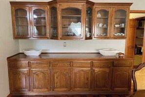 Traditional kitchen with classic cabinetry, glass panel doors, and a central island for added functionality.