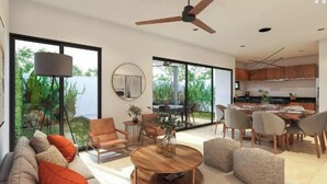 Un salon moderne doté d’un ventilateur de plafond, de grandes fenêtres et offrant une vue sur l’extérieur.