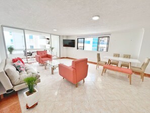 Relax in this stylish living room with a sofa, coffee table, and armchair, perfect for unwinding with a view.