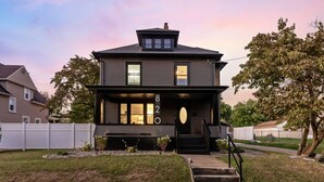 A two-story house with a number '820' on the front, a front porch, and a staircase leading to the entrance. - Live the Game: Pool, Cinema, Gym, Jersey Wall (Massillon)