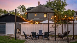 A backyard with a patio area, outdoor furniture, and string lights. - Live the Game: Pool, Cinema, Gym, Jersey Wall (Massillon)
