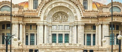 A grand building with a large dome, columns, and statues.