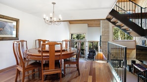 A dining area with a wooden table and chairs, a chandelier, and a staircase leading to an upper level. - Wonderful Mountain Home, Hot Tub, Complimentary Shuttle to Slopes (Beaver Creek)