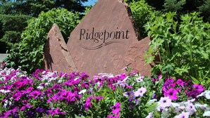 A sign with the name 'Ridgepoint' surrounded by vibrant flowers. - Wonderful Mountain Home, Hot Tub, Complimentary Shuttle to Slopes (Beaver Creek)