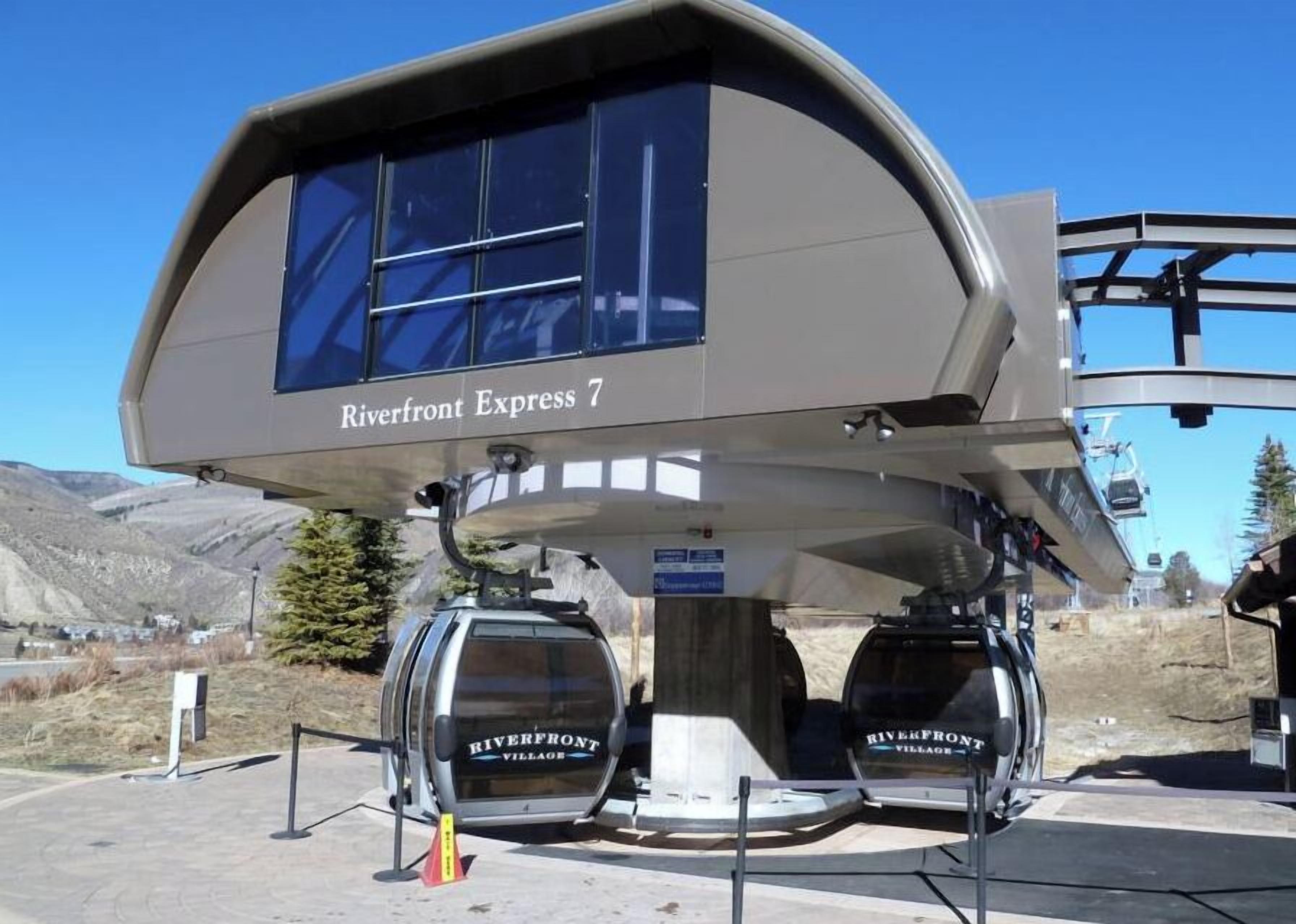 A modern lift station with the name "Riverfront Express 7" and two cabins labeled "Riverfront Village".