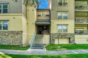 A multi-story residential building with a stone facade, a central staircase, and a small porch area. - Beautiful Mountain Condo 10 Minutes from Beaver Creek, BBQ (Edwards)