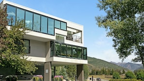 En moderne bygning med to etager, store vinduer og en balkon.