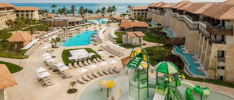 A resort with multiple swimming pools, a water park, and beachfront accommodations.
