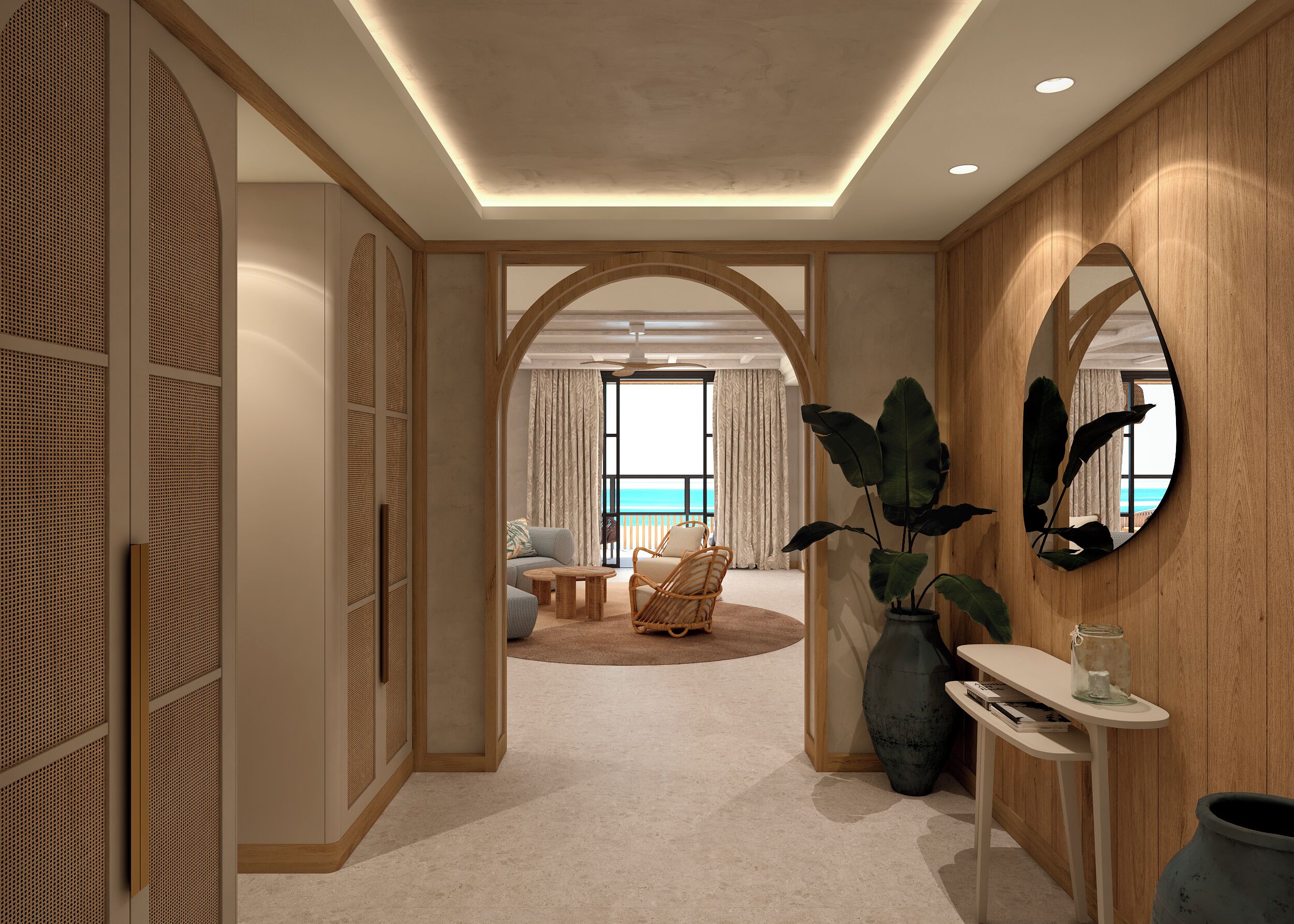 Una habitación de hotel moderna con un amplio arco que da a un balcón con vistas al mar. Cuenta con una zona de estar con sofá y sillones, y una mesita con un jarrón de flores.