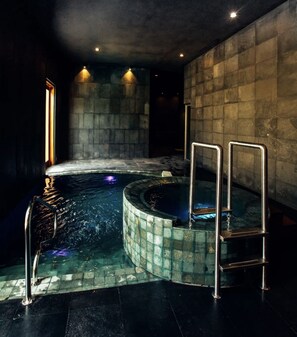 Relax in a serene spa area featuring a circular hot tub with metal handrails.