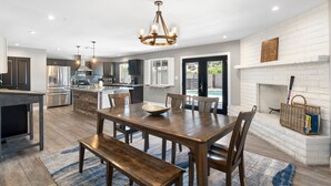A modern kitchen with a central island, stainless steel appliances, and pendant lighting. - Sparkling Pool  Putting Green in Tempe (Tempe)