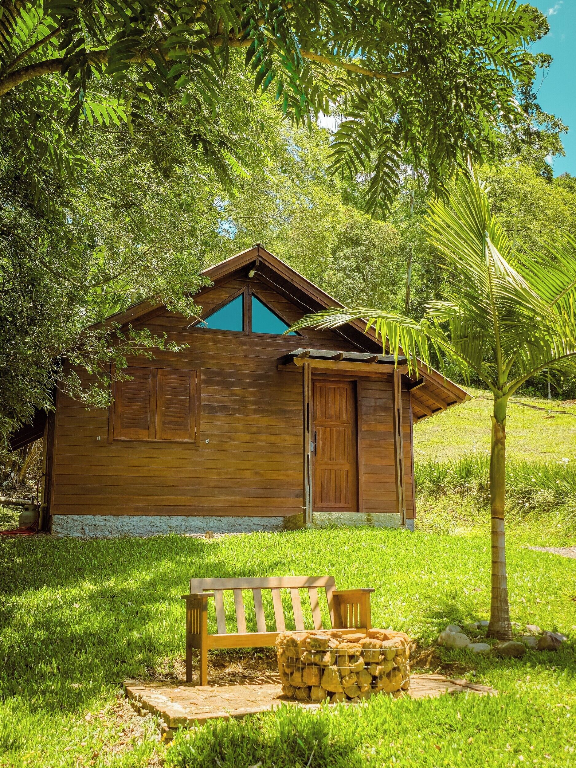 A wooden cabin with a sloped roof, a door, and a window.