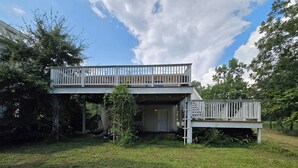 A two-story house with a balcony and a covered porch area.