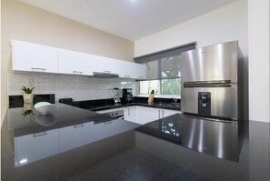 Full-size fridge, toaster, blender, cookware/dishes/utensils