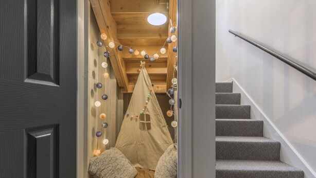 A staircase leading to a room with a tent-like structure decorated with lights. - Large 4BR Home, Garage – Short & Long Stay (Pleasant Valley)