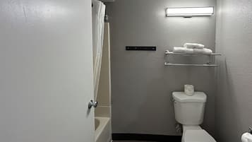Combined shower/bathtub, towels, toilet paper