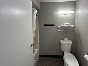 Combined shower/bathtub, towels, toilet paper