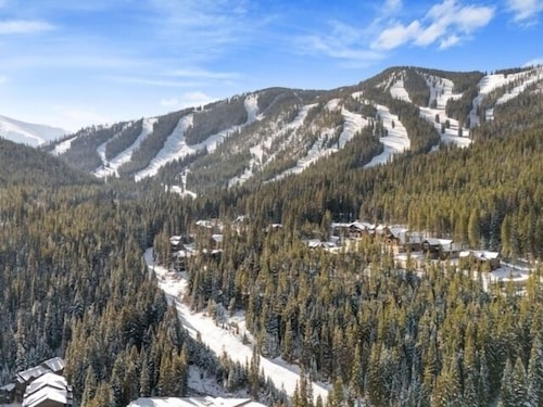 1st floor ski in & out resort condo with hot tubs, fitness room, covered garage.