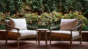 Two wooden armchairs with cushions, a small round table, and a brick patio. - Stockton Inn (Stockton)