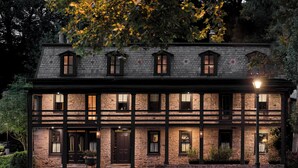 A two-story stone building with multiple windows and a dark entrance door. - Stockton Inn (Stockton)