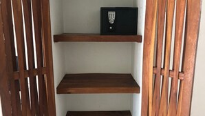 A wooden shelf unit with a remote control on top. - Bungalows Adelamar (Zihuatanejo)