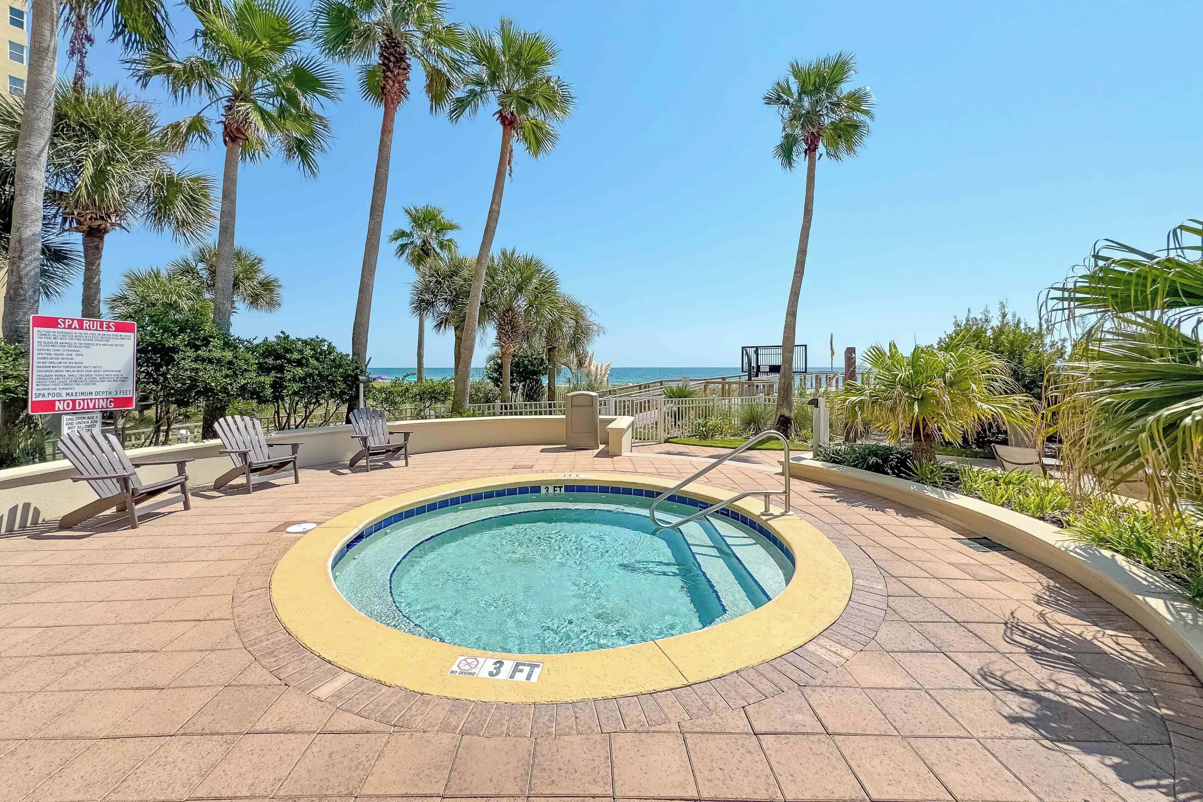 A pool area with lounge chairs, a sign indicating no diving, and a 3 FT depth marker.