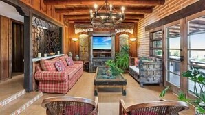 TV, fireplace, books - "Scarritt House"  Small Deluxe Blue Bedroom. (Tucson)