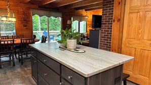 A kitchen with a marble countertop, wooden cabinets, and a potted plant. - Modern, 2 King, 4 BDRM Private Luxury Log Cabin, 5 Star, Family Friendly (Intervale)